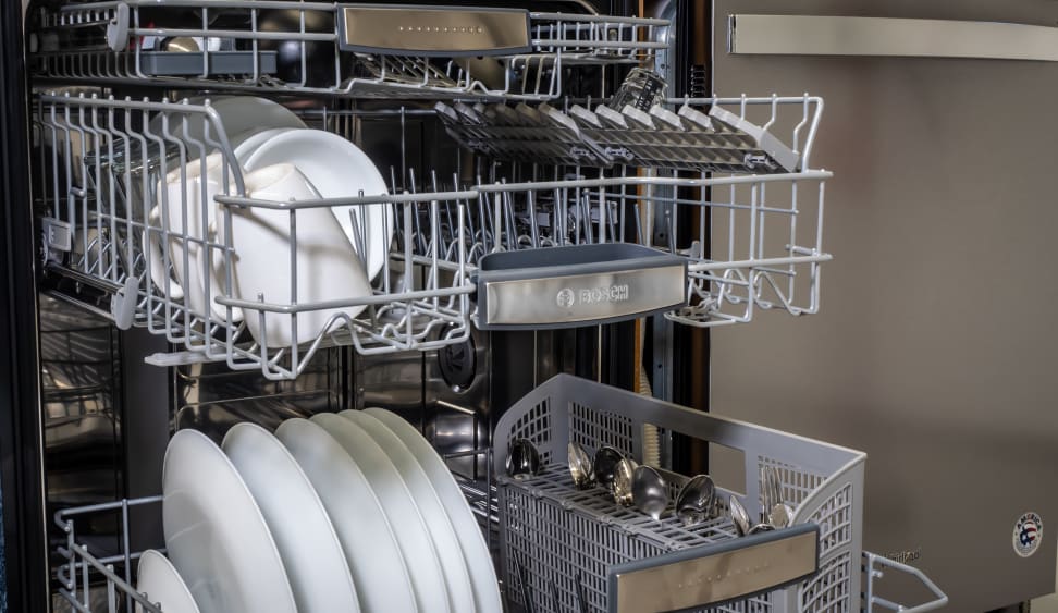 A close-up of the racks inside the Bosch 800 Series SHE88PZ65N dishwasher, fully stocked with freshly-washed dishes.