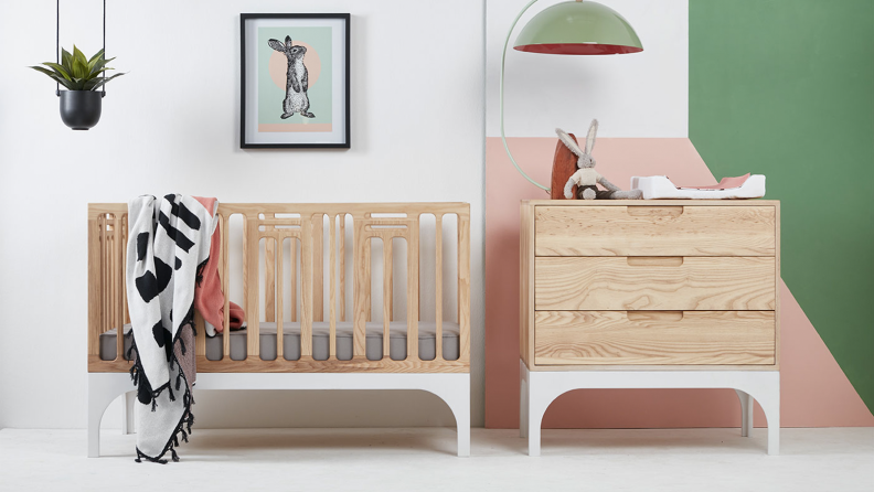 A nursery with multiple pieces of wooden furniture