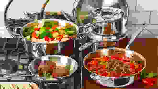 assortment of pots and pans with variety of food in each