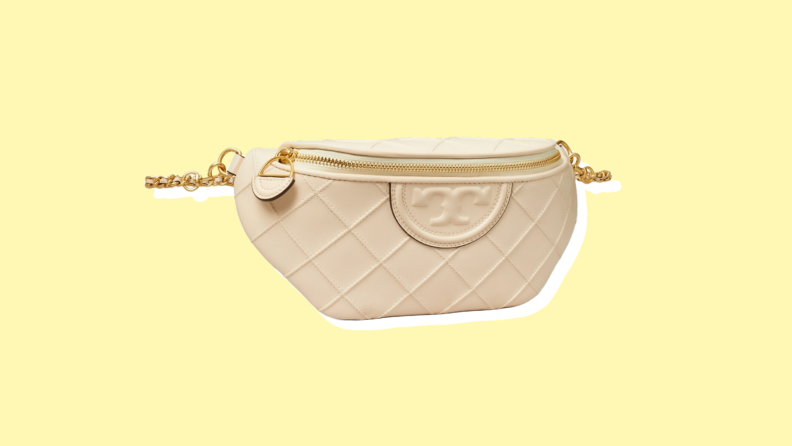 Photo of the Tory Burch Fleming Soft Convertible Belt Bag against a yellow background.