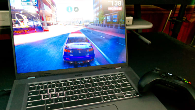 A video game on the screen of the Acer Chromebook laptop next to a video game controller.