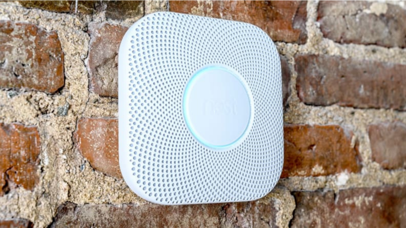 Smoke detector mounted on a brick wall