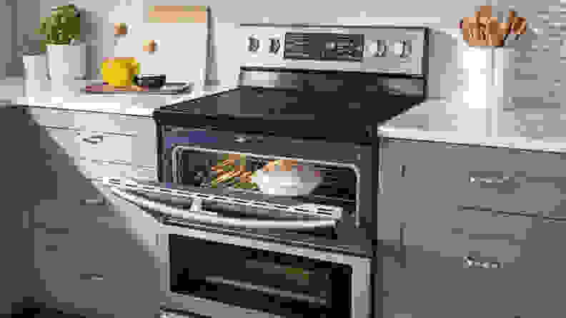 The  Samsung NE59J7850WS electric range shown with it's top oven door open. There is a lemon meringue pie in the oven.