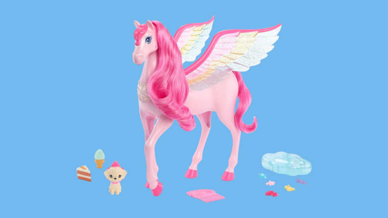 A Barbie Pegasus doll stands next to a blue ice cream cone, a slice of pie, a puppy, a comb, and other accessories.