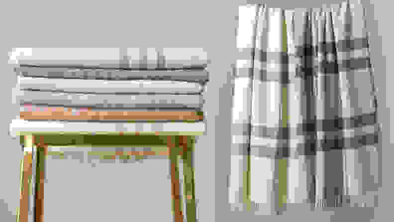 Left: Stack of folded blankets on stool; Right: Two wool blankets hanging up