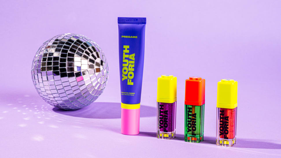 A disco ball next to four Youthforia products aligned in a row.