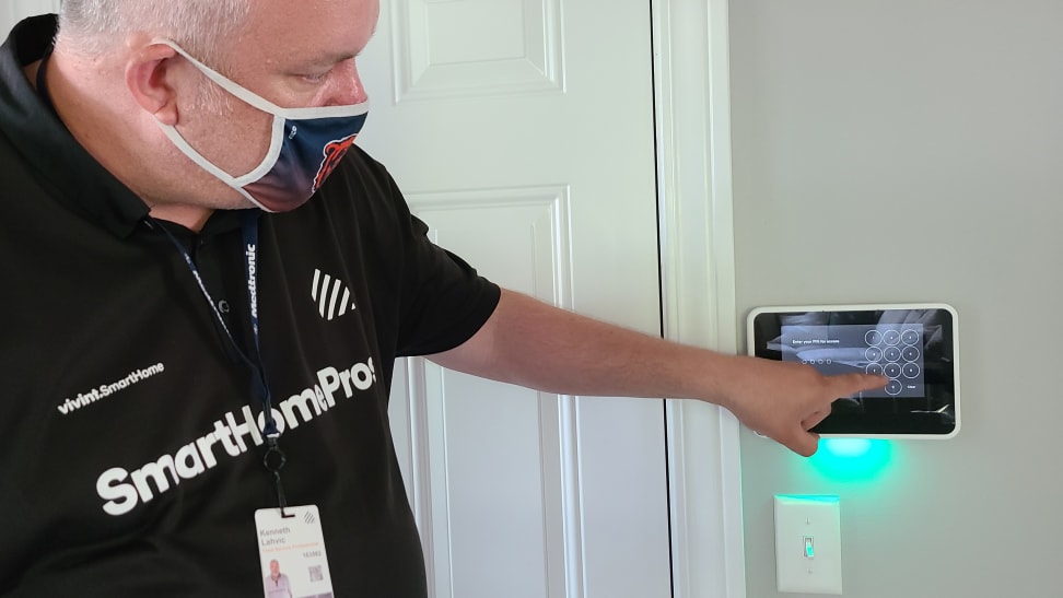 Person touching screen of Vivint hub