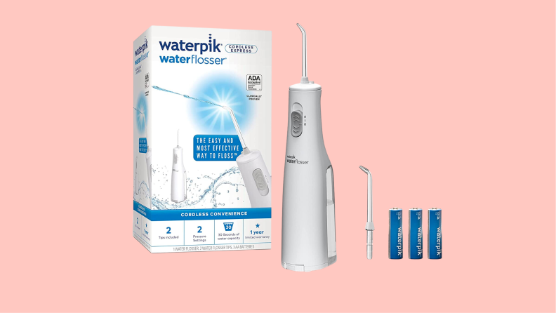 A water flosser and accessories appear on a pink background.