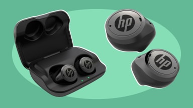 Product shot of set of HP Hearing Pro OTC hearing aids inside of charging case and out of it.