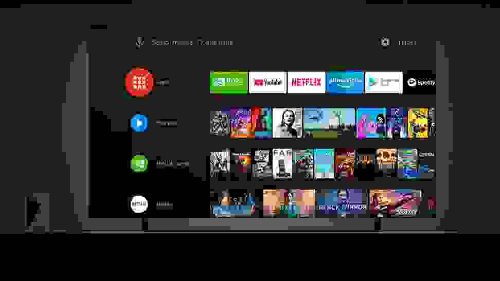 An Android TV box being used on a television to display different streaming services.