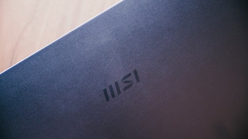 A close up shot of the top of the laptop with the MSI logo