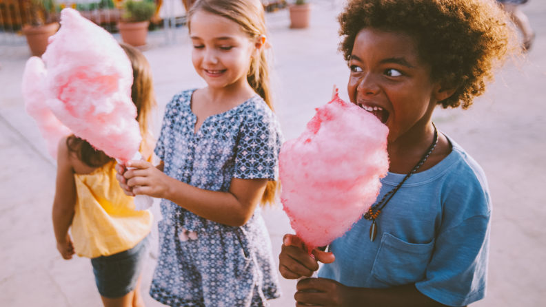 Girls eating pink cotton candy