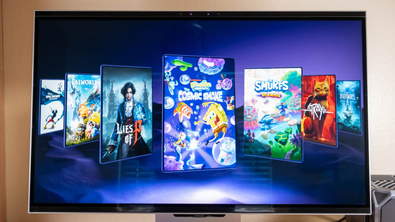A 3D monitor stands on a desk with video games on its screen