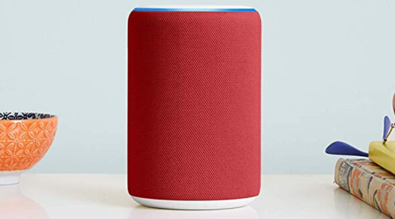 A red-colored Amazon Echo (third-generation) speaker sits on a countertop.