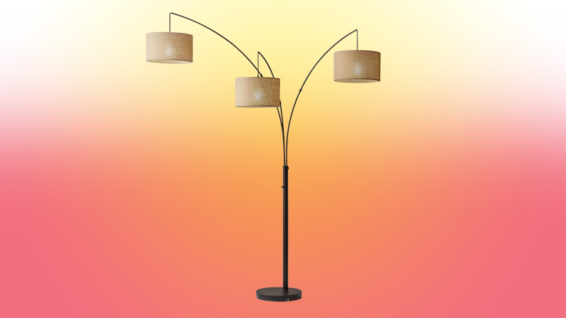 A lamp stands on a red and yellow fade background