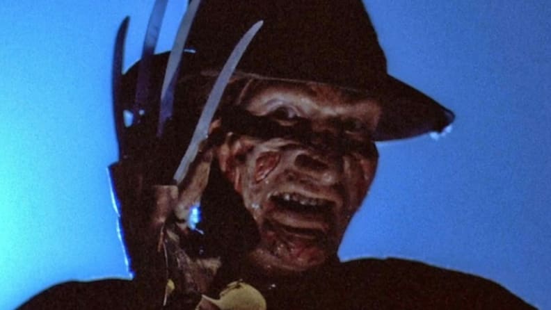 A close-up of Freddy Krueger, with bladed glove partially covering his face, from "A Nightmare on Elm Street."