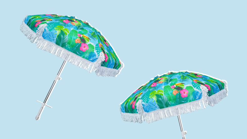 Two floral-printed umbrellas against a blue background.