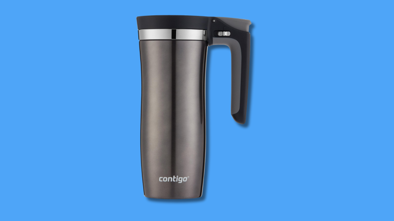A gray travel mug with a handle against a blue background.