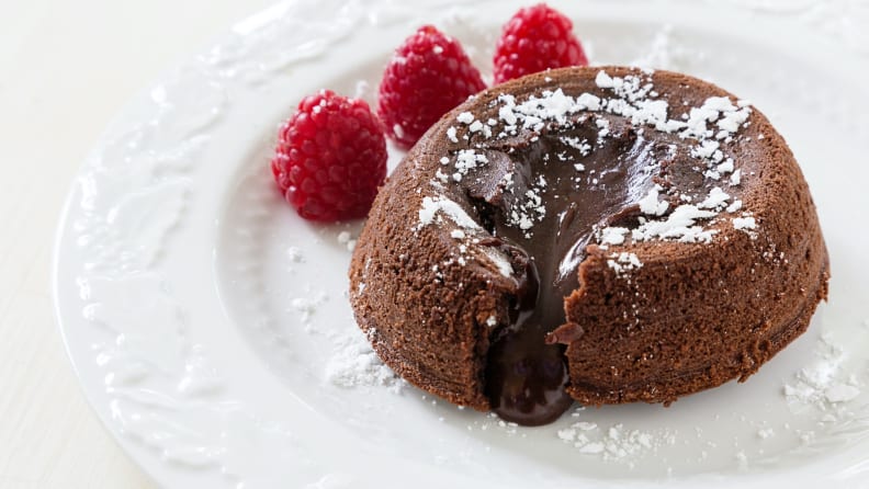 Lava cake and fresh raspberries and a sprinkling of icing sugar.