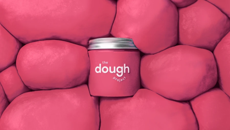 Red play dough on a background of dough balls