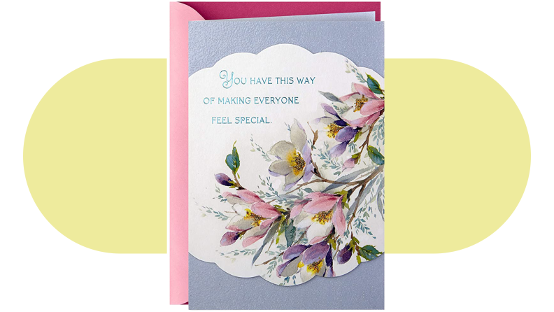 Multicolored Hallmark greeting card with flowers on front .