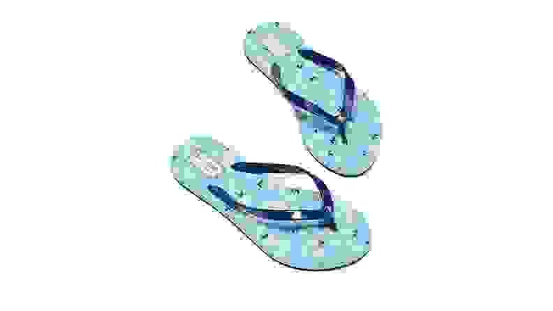 A pair of blue Kate Spade sandals against a white background.