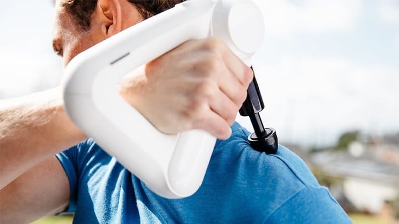 Man holding massager to his shoulder.