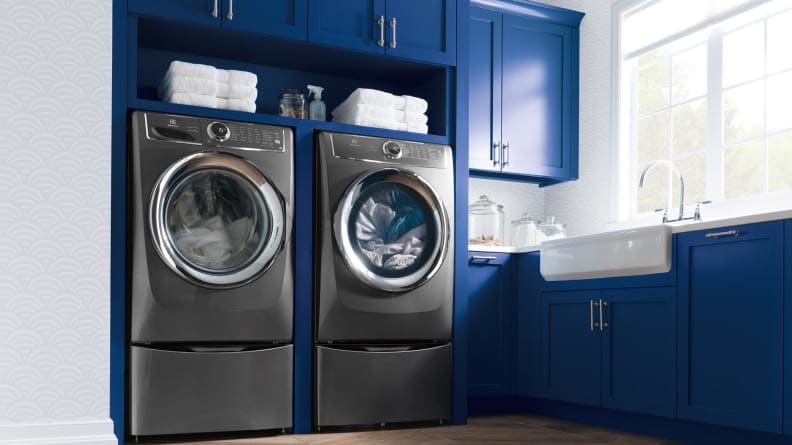 electrolux grey washer and drier set in blue room.
