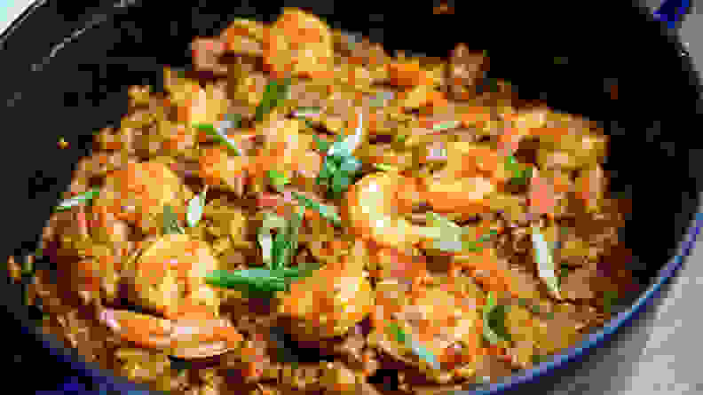A pan of jambalaya, with rice, shrimp, and fresh herbs.