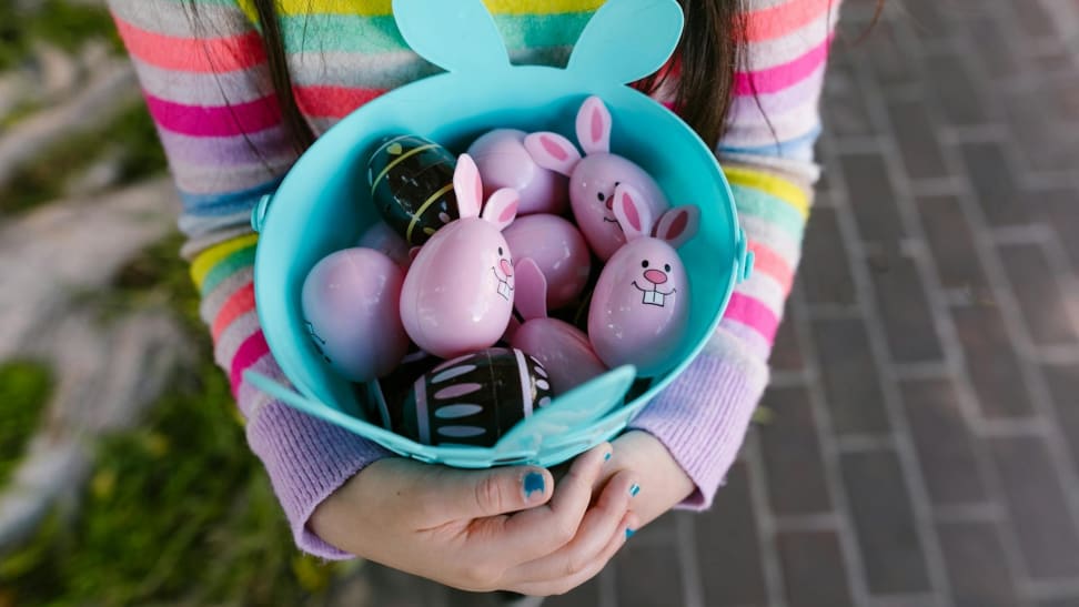 Girl carrying an Easter bucket full of Easter eggs