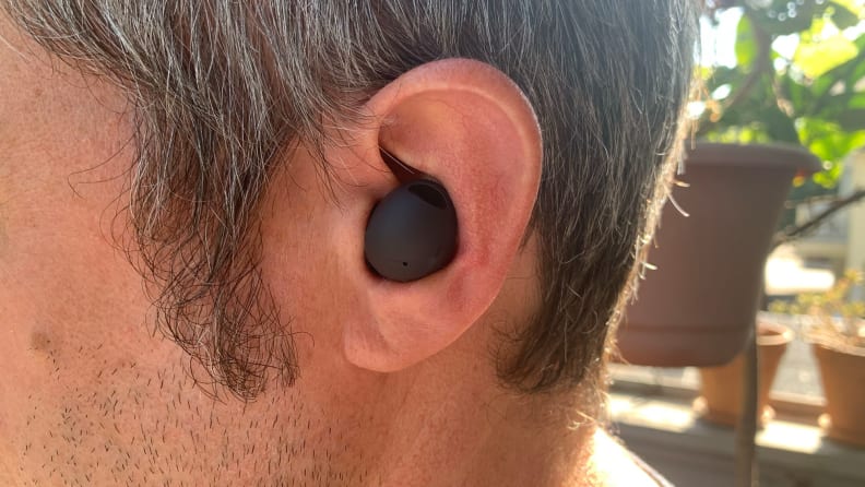 A man with the Samsung Galaxy Buds 2 Pro earbuds in his ear.