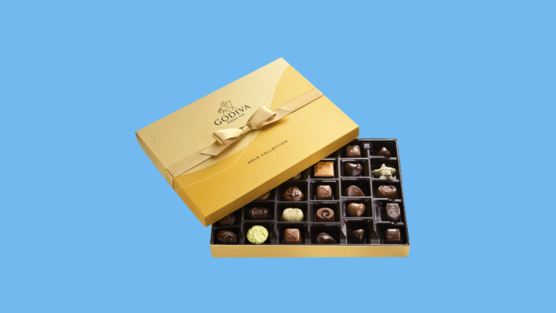 Open box of Godiva against blue background