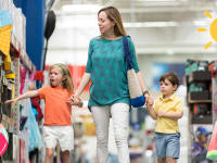 A mom and two kids shop for summer toys at a warehouse store, highlighting the fun of a Sam's Club membership deal.
