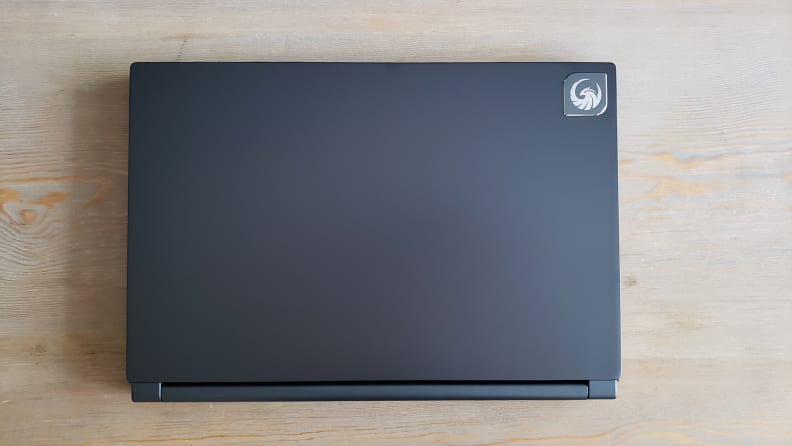 A closed laptop on a wooden coffee table