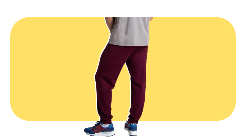 Model wearing burgundy jogger pants and sneakers.