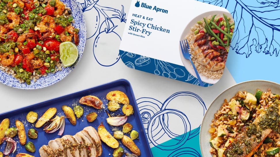 An image shot from above of several Blue Apron Wellness prepared dishes, including the packaging of the premade Spicy Chicken Stir-Fry.