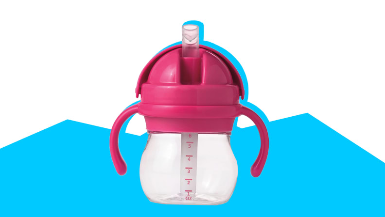 A pink OXO sippy cup on a white and blue background