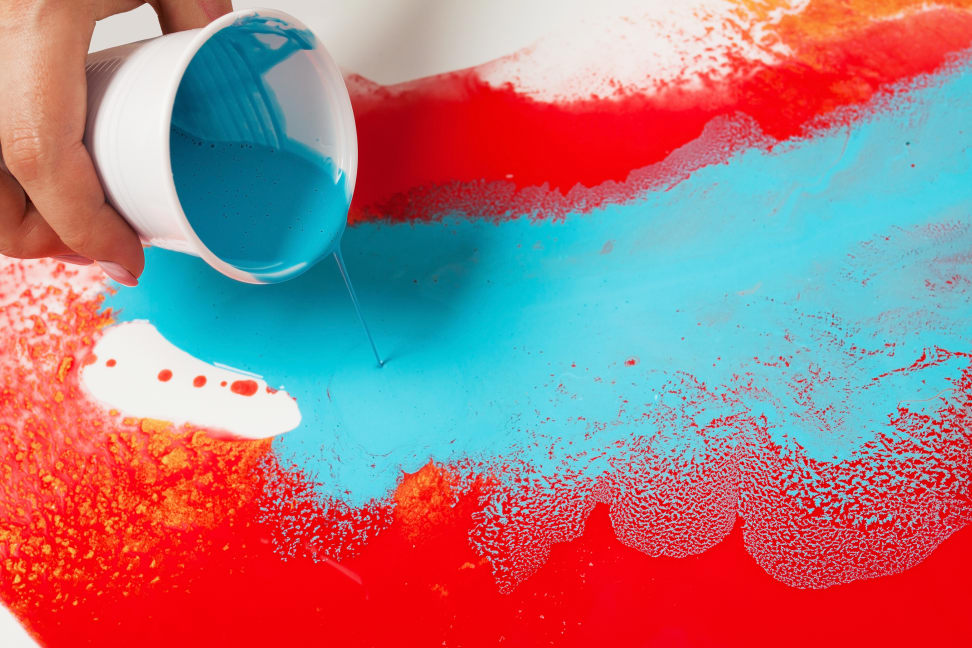 paint being poured on a canvas