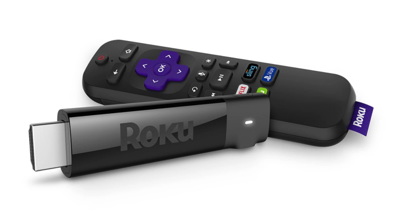 Someone holding a small Roku station