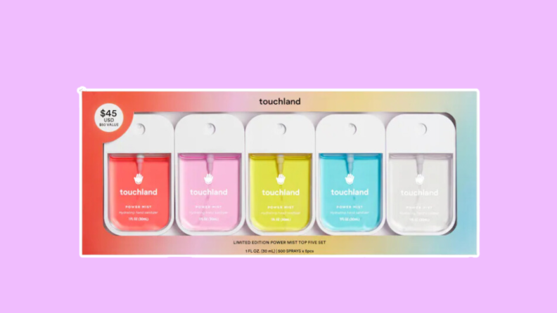 A set of five colorful Touchland power mist hand sanitizers on a purple background