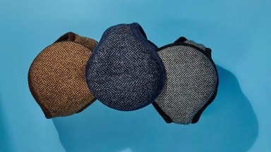 A set of earmuffs on a blue background.