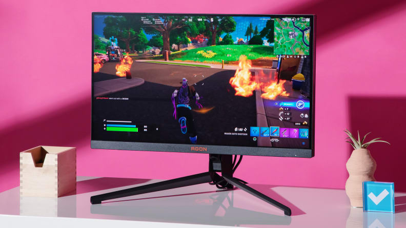 The AGON PRO on a white desktop with a video game on the screen.