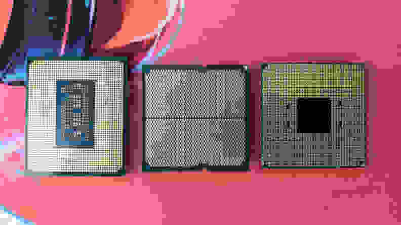Three computer processors lined up on a mat.