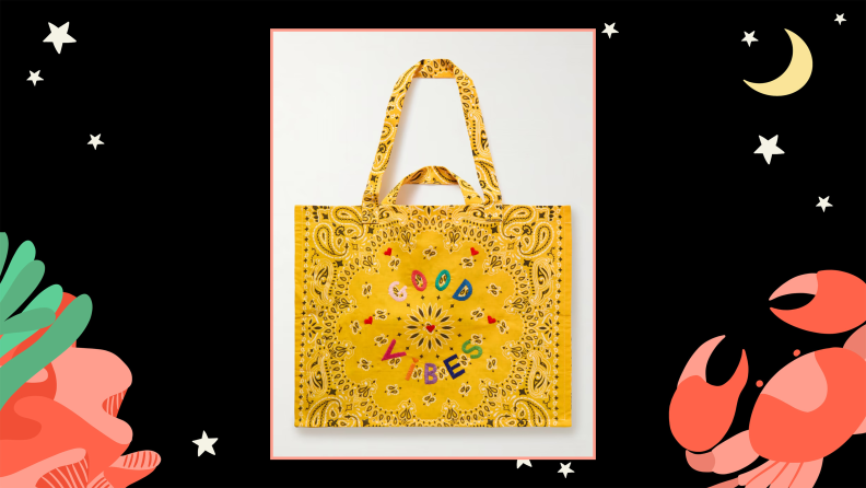 A tote bag that has a handkerchief print and is embroidered with the words ‘Good Vibes.’