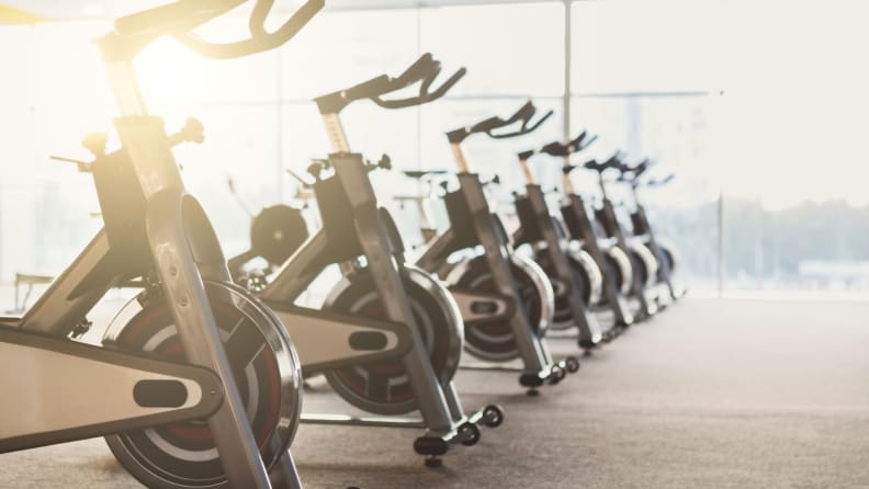 Modern gym interior with equipment. Fitness club with row of training exercise bikes. Healthy lifestyle concept