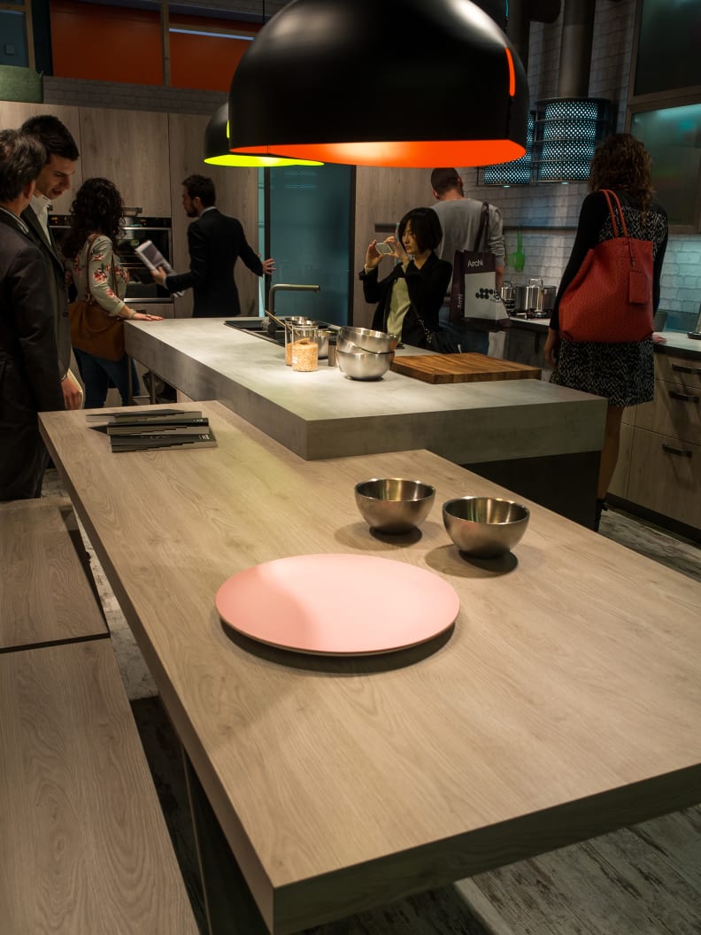 At least one of Snaidero's EuroCucina kitchens featured an overlapping combo of wood and stone.