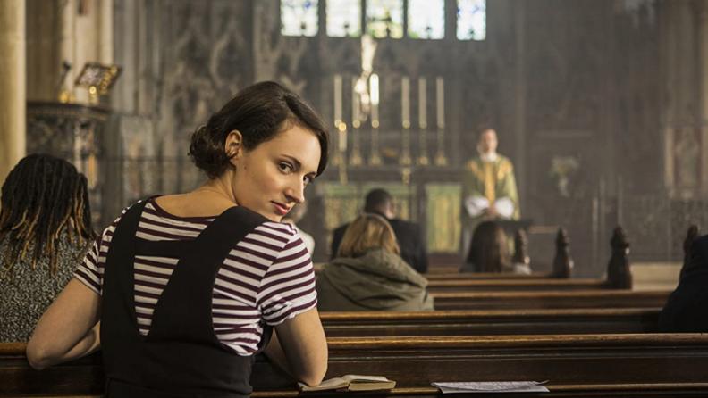 A still from the series Fleabag featuring Phoebe Waller-Bridge in a church.