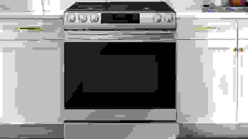 Samsung oven range next to white cabinets in modern kitchen.