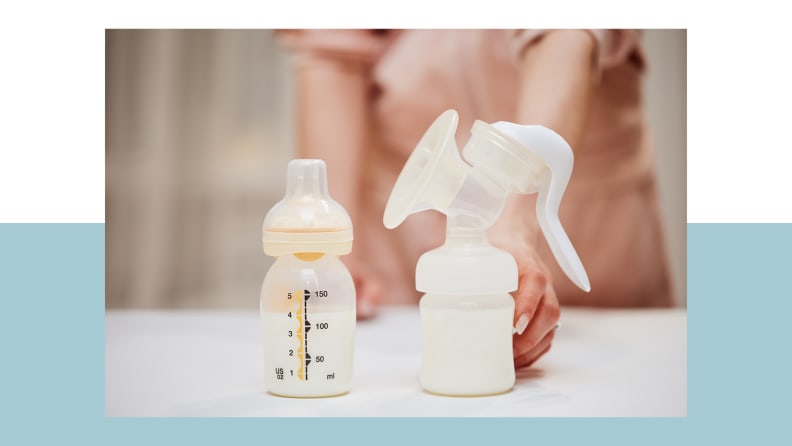 Person holding breast pump filled with milk on counter next to filled baby bottle.
