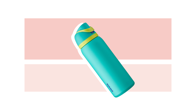 A blue water bottle against a pink and light pink background.